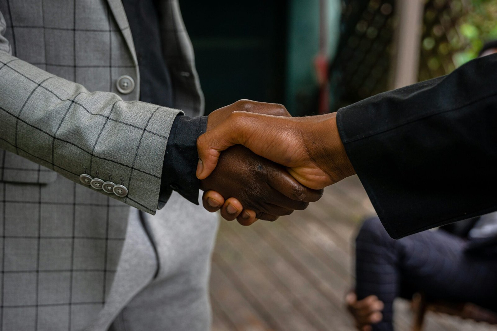 A close-up of a man's thumbs up gesture, symbolizing success and agreement.